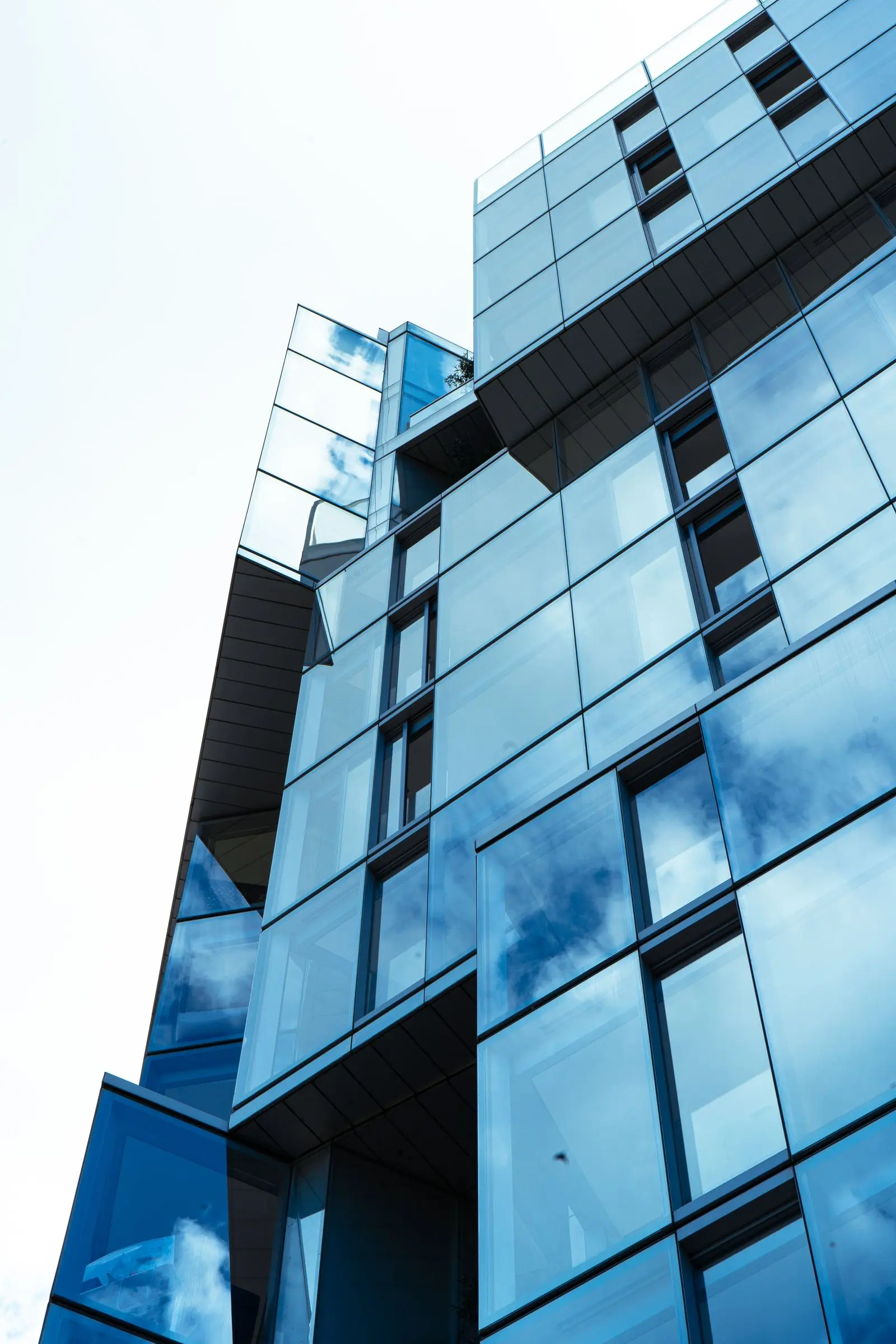 Low-angle view of a commercial building facade with aluminum storefront glazing